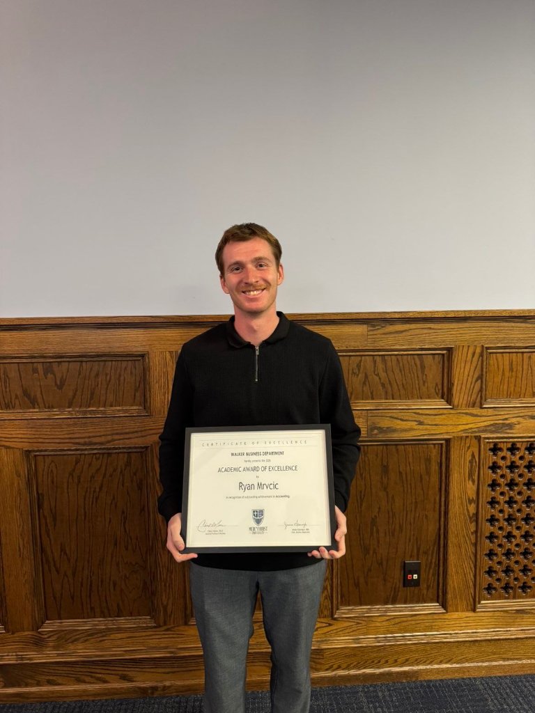 Ryan Mrvcic with his Academic Award of Excellence certificate from Mercyhurst University
