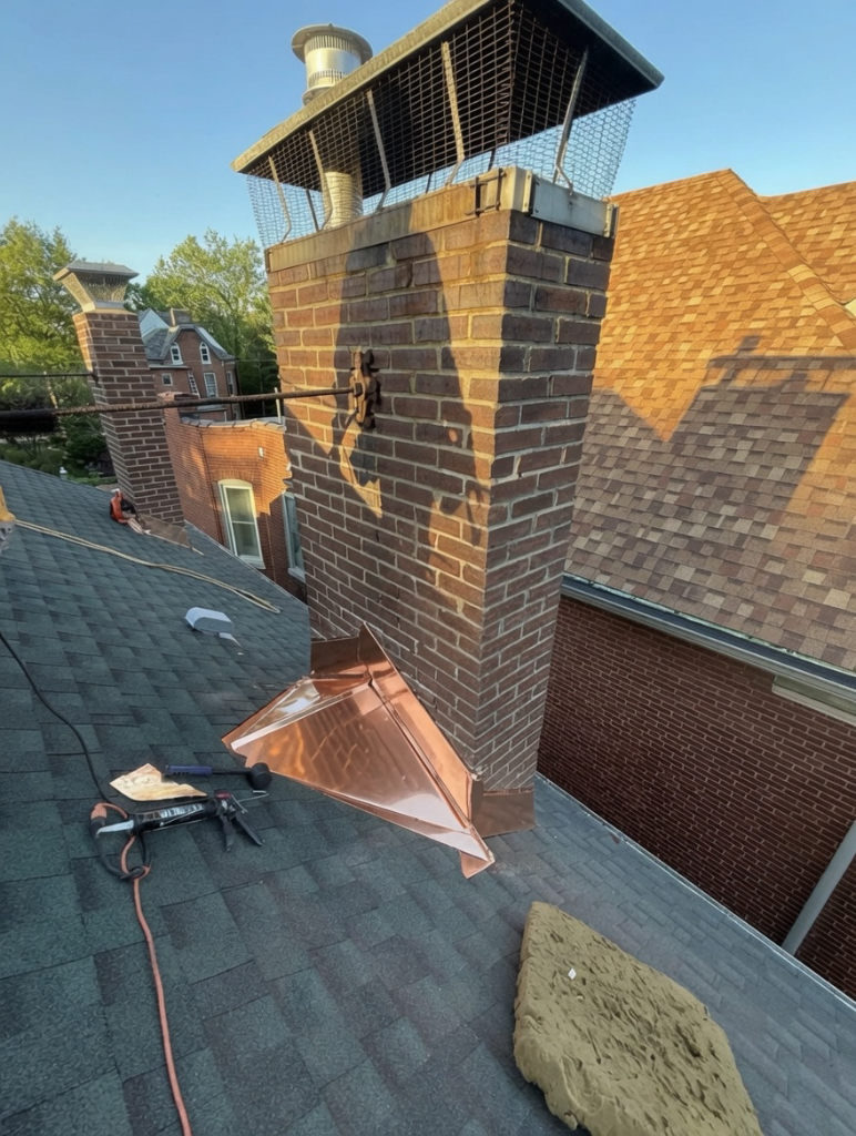 Custom copper cricket at chimney base