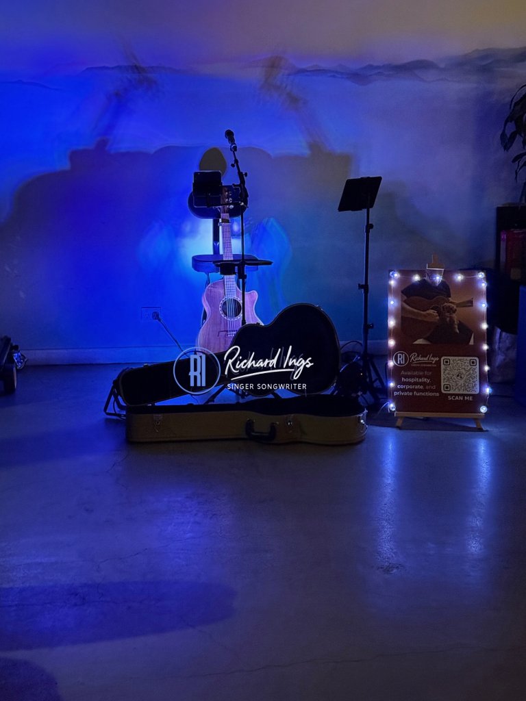 Richard Ings stage setup with blue lighting at a Canberra venue