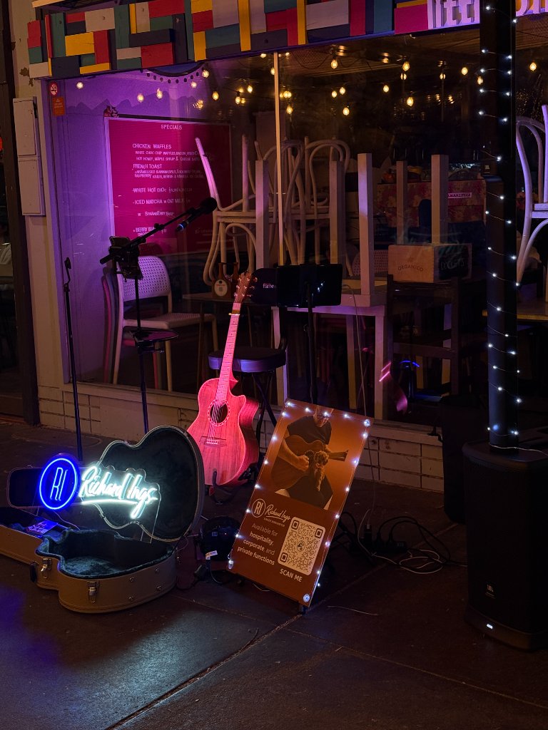 Richard Ings guitar setup with pink stage lighting at a Canberra bar