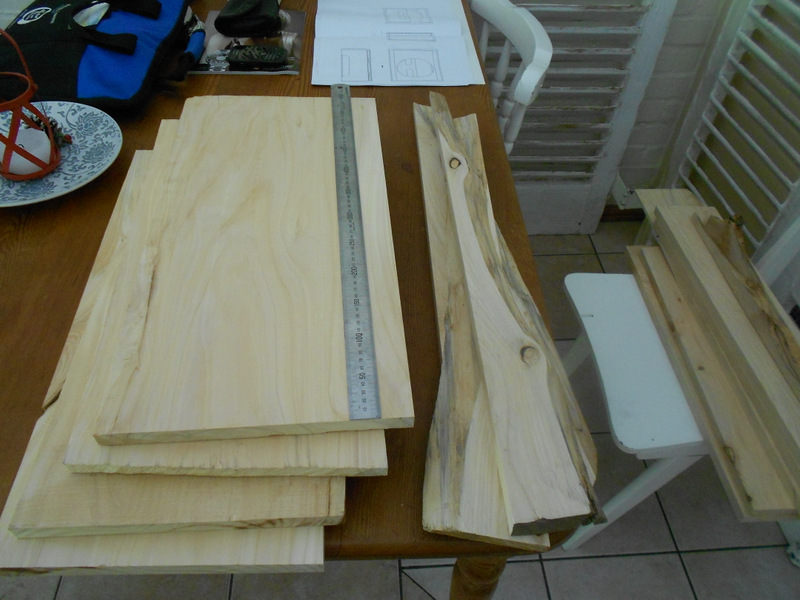 Pine boards and cabinet drawings on the dining table