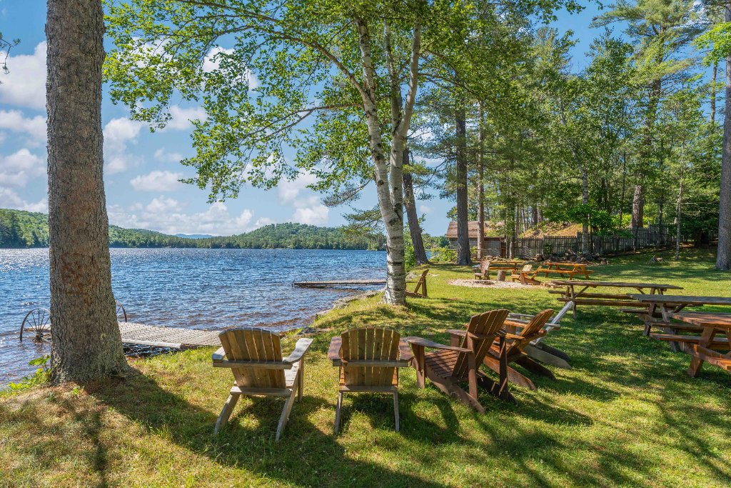 Lakefront Adirondack chairs on a sunny Maine day