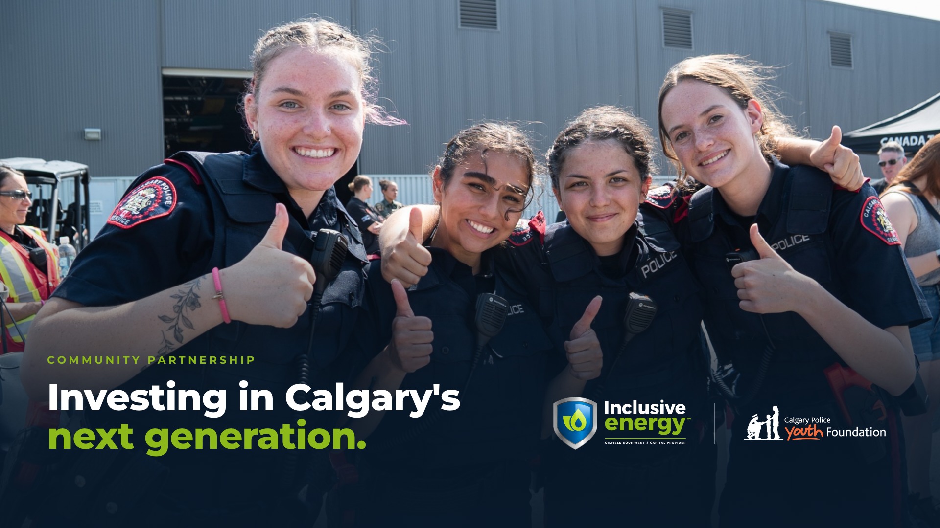 Calgary Police officers give a thumbs up at the Inclusive Energy yard