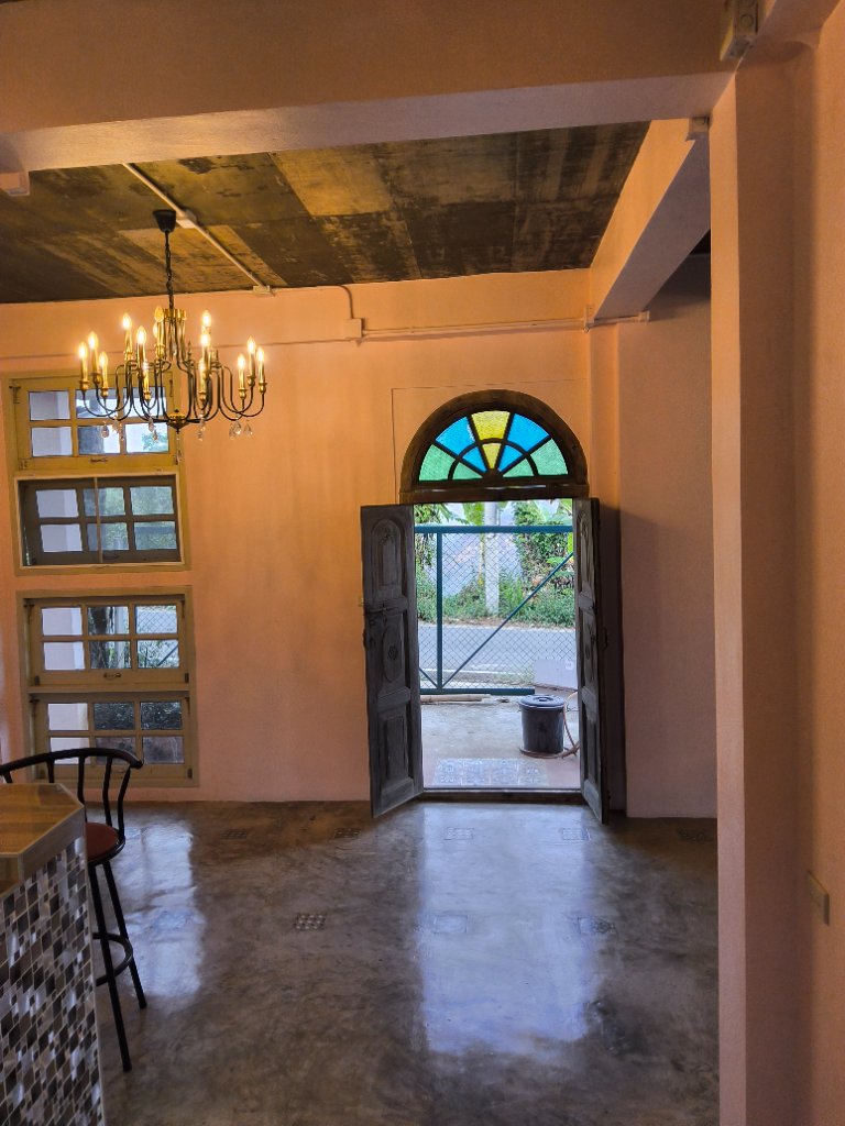 Café interior with stained glass door open