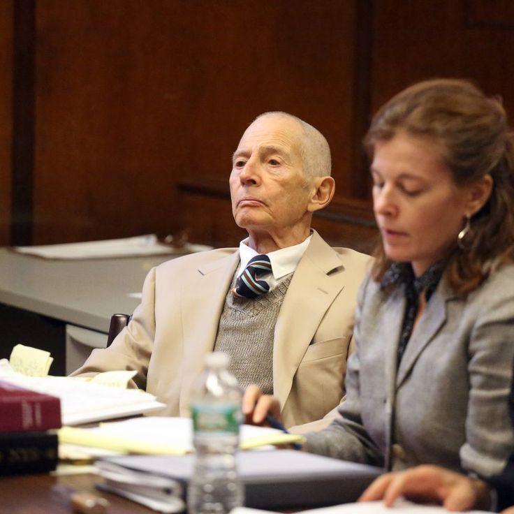 Robert Durst in orange jumpsuit being arrested