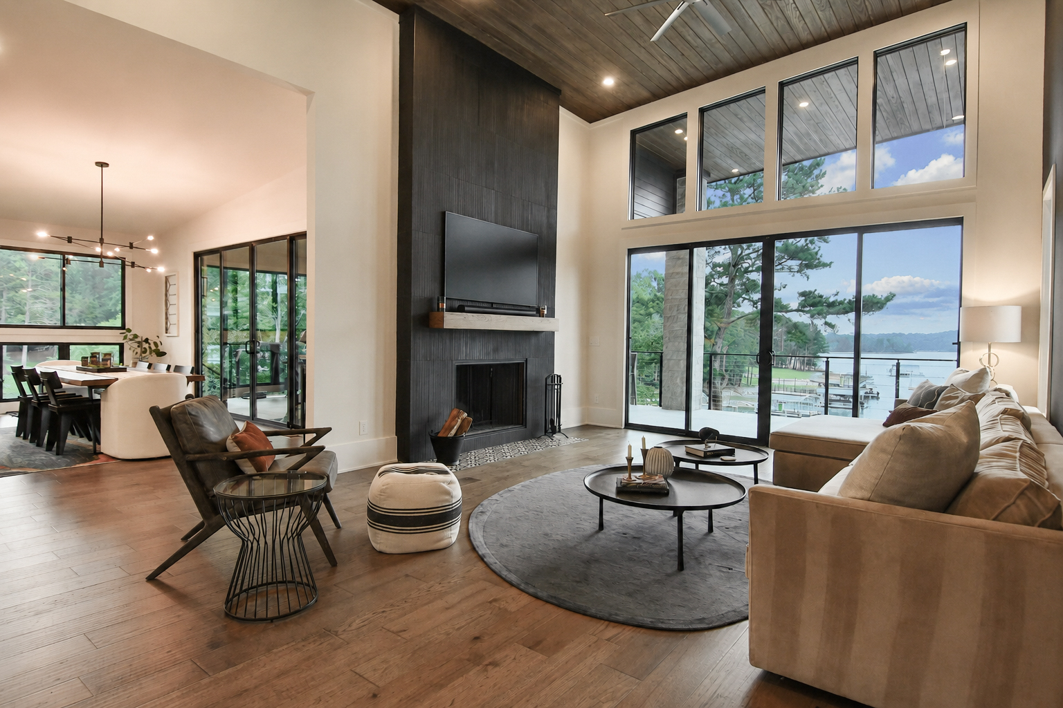 Modern craftsman lakefront custom home built by Kade Homes & Renovations on Lake Lanier, GA, with a vaulted great room and floor-to-ceiling glass doors