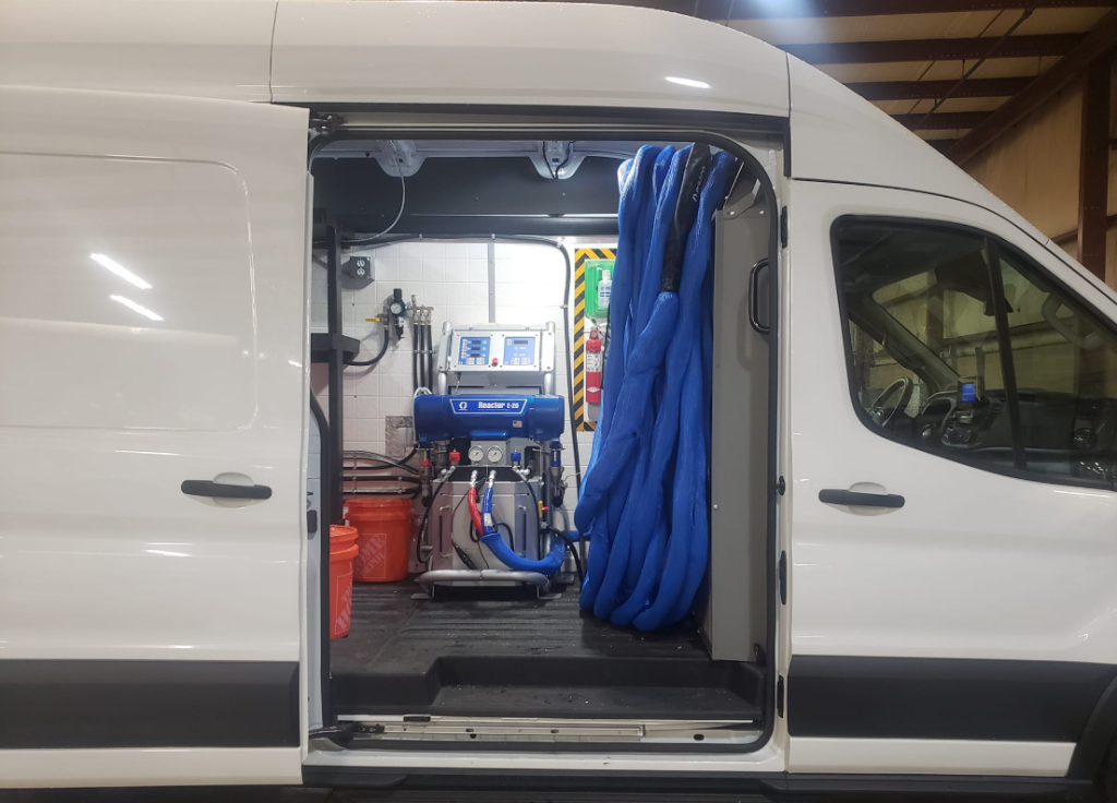 Custom spray foam rig interior showing equipment layout and hose management