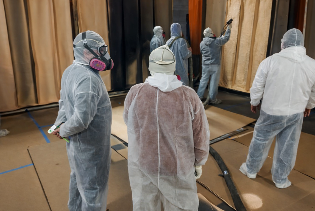 Professional spray foam application technique demonstration on building insulation