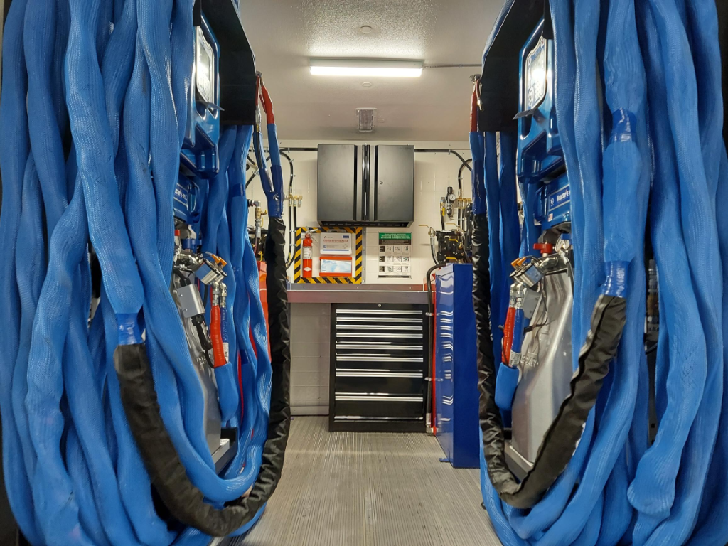 custom spray foam rig interior with blue heated hose reels