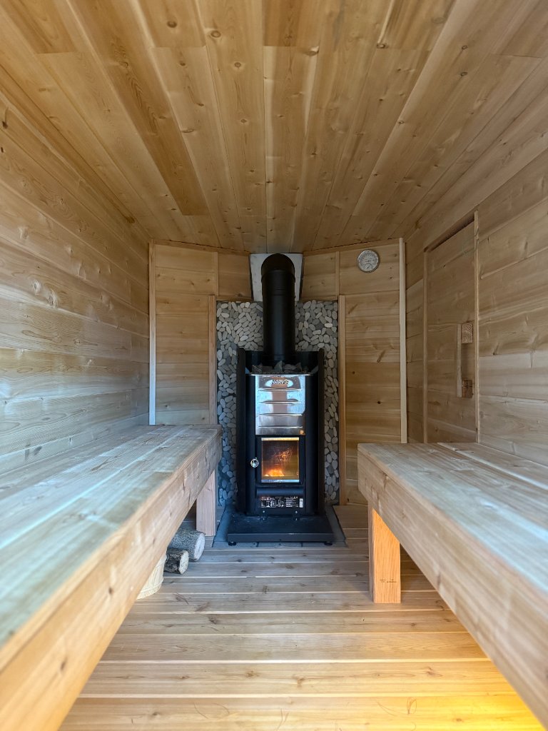 Inside the sauna with wood-fired kiuas