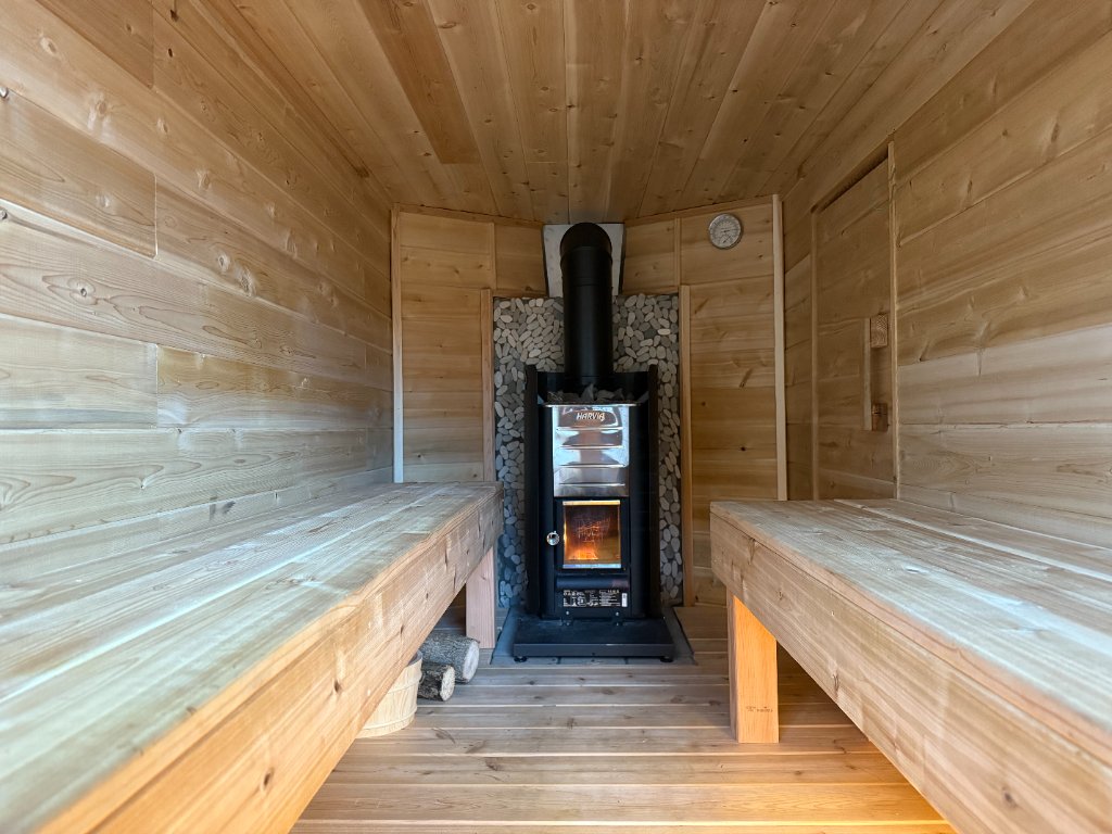 Inside our mobile sauna with wood-fired Harvia kiuas