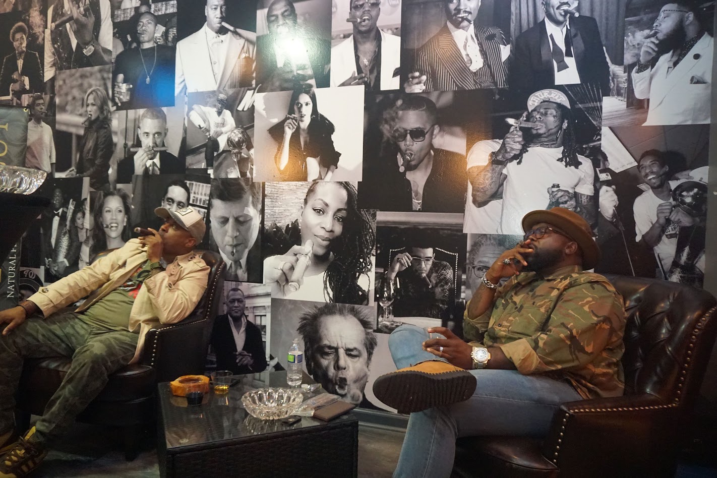 Two men enjoying cigars together in a lounge setting