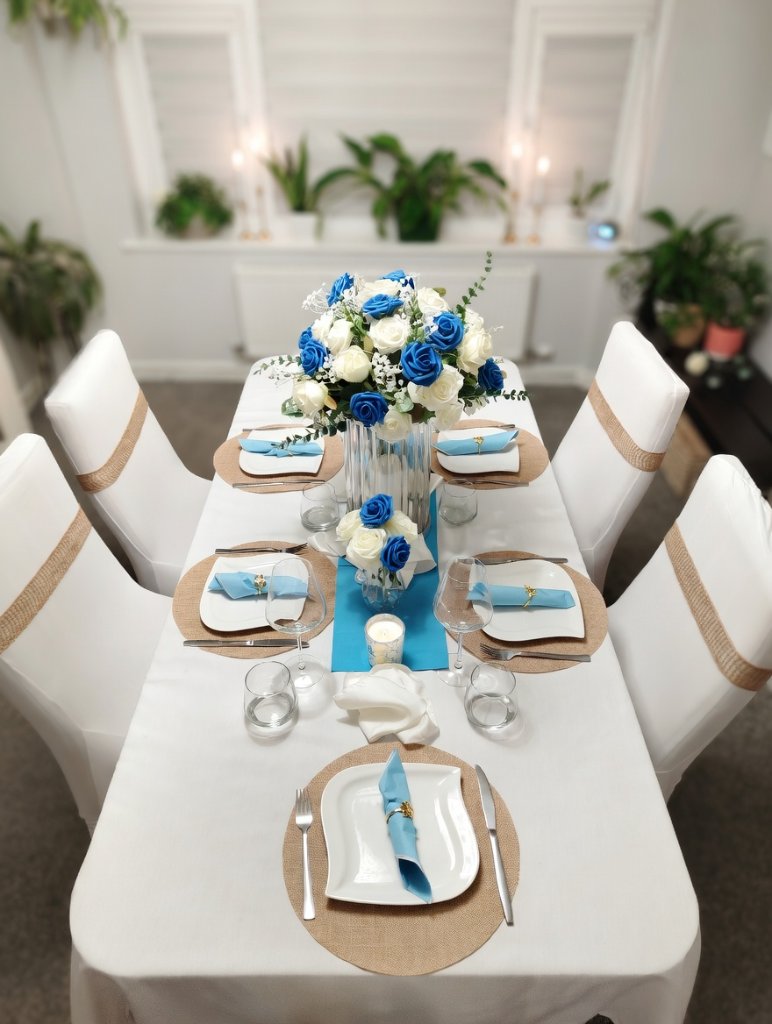 Elegant blue and white wedding table setting with floral centrepieces
