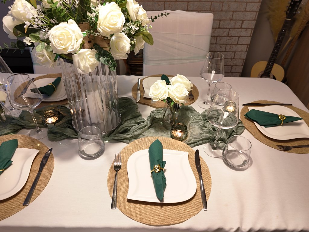 Emerald green wedding table setting with coordinated place settings