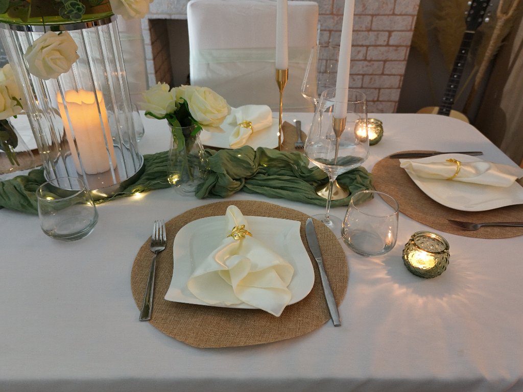 Ivory and gold place setting with fine tableware and napery