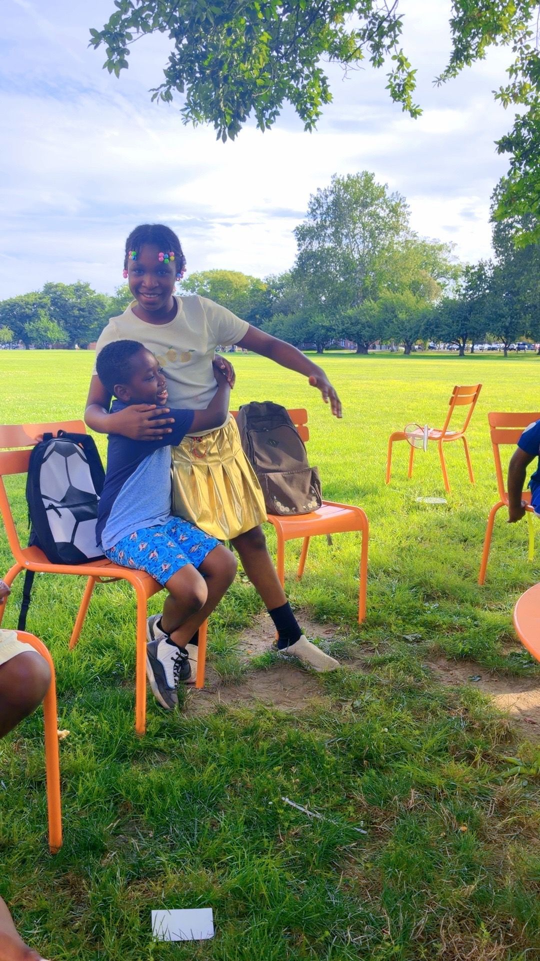 Junior TULA friends sharing a hug at the park