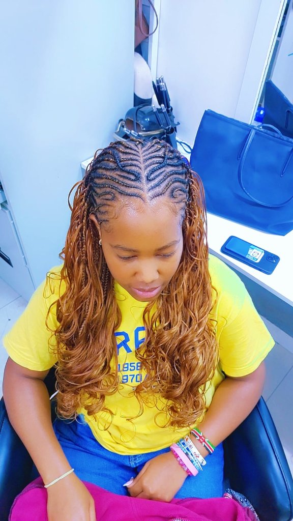 Cornrows transitioning to wavy extensions