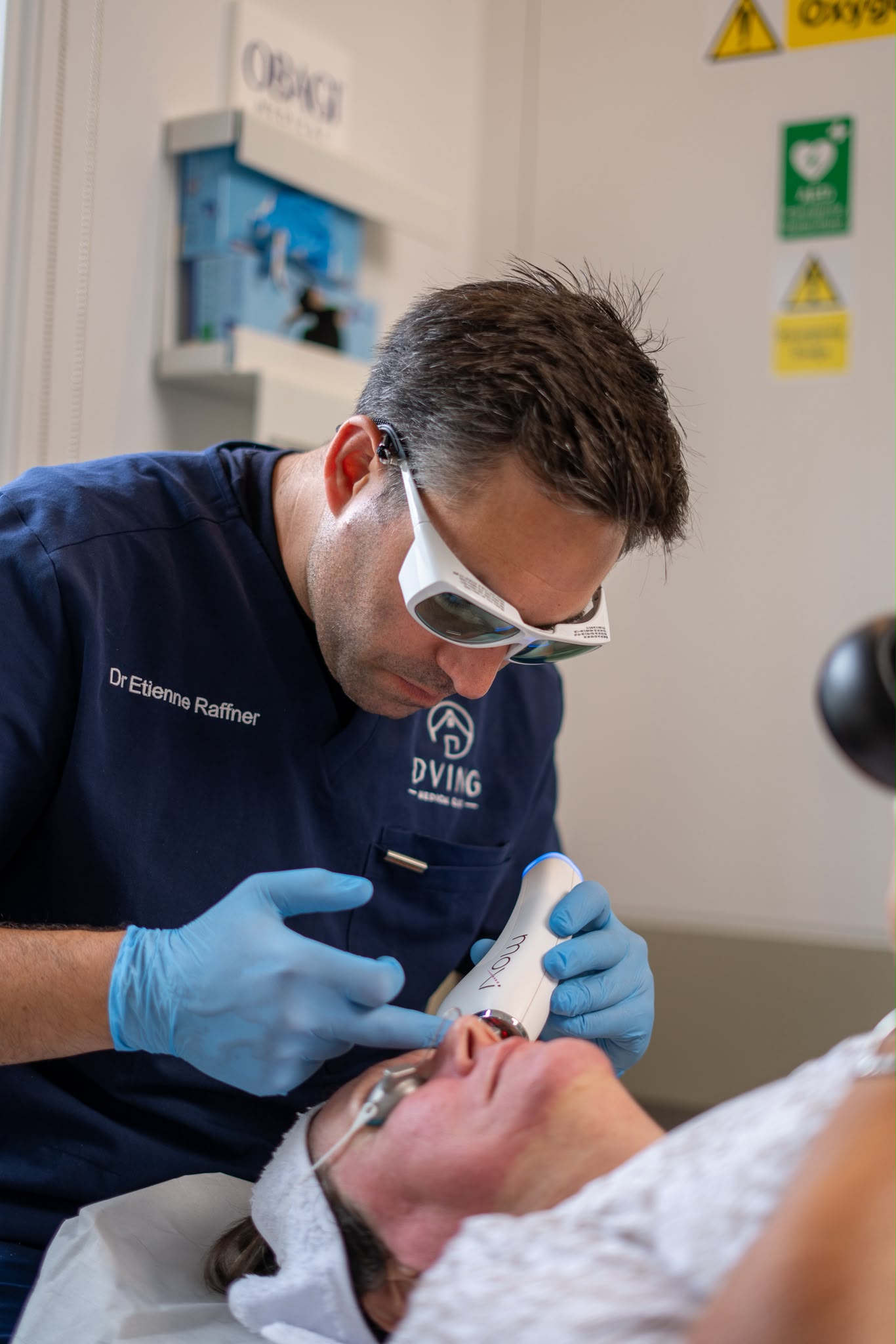 Dr Etienne Raffner performing a MOXI laser treatment on a patient