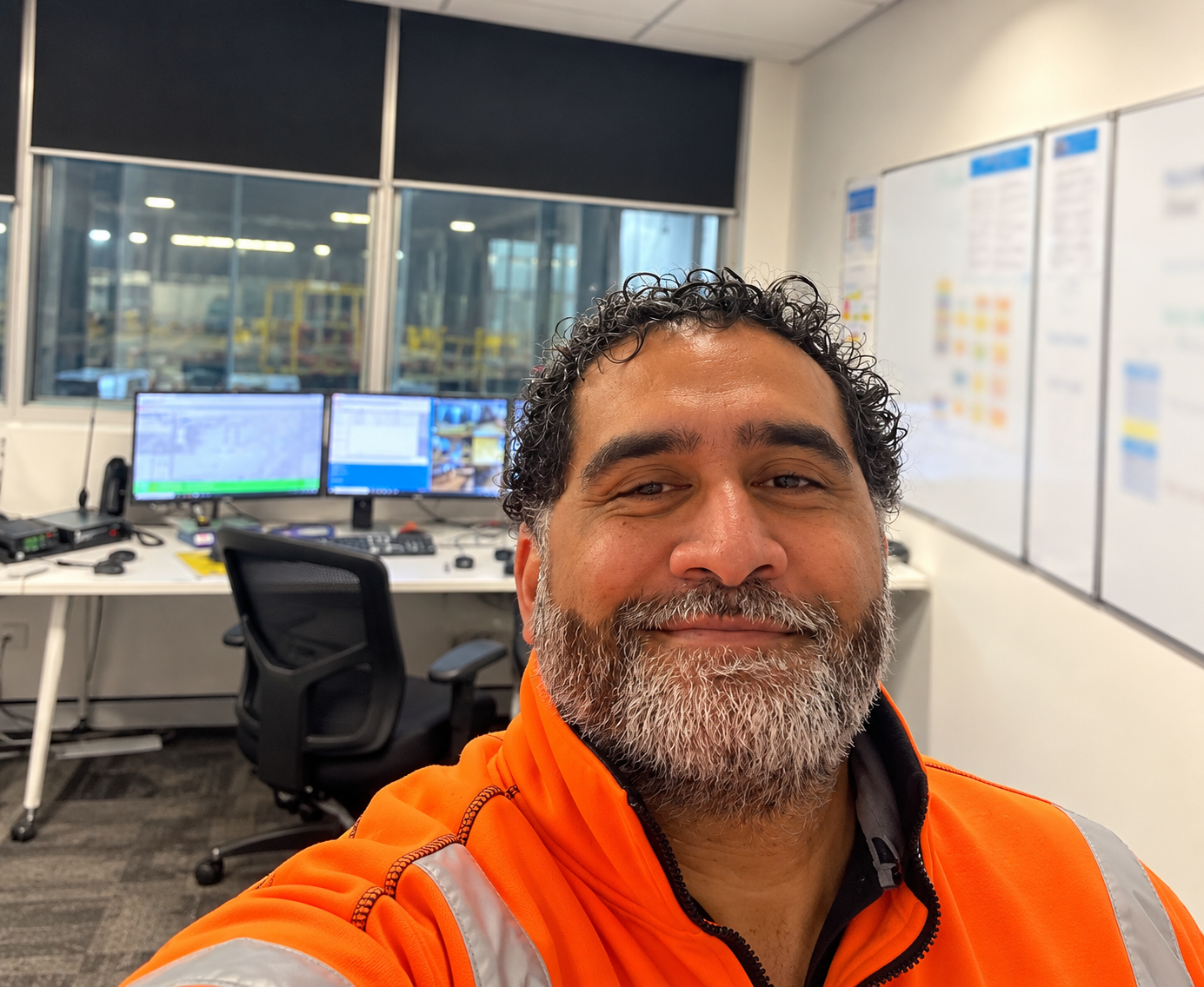 Pierre Walter in high-visibility workwear inside an operational control room.