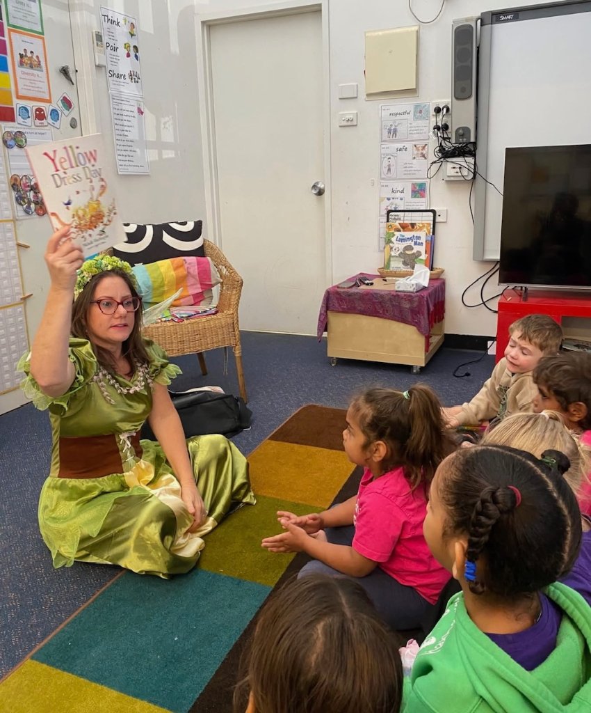 Storyteller in costume reading to children