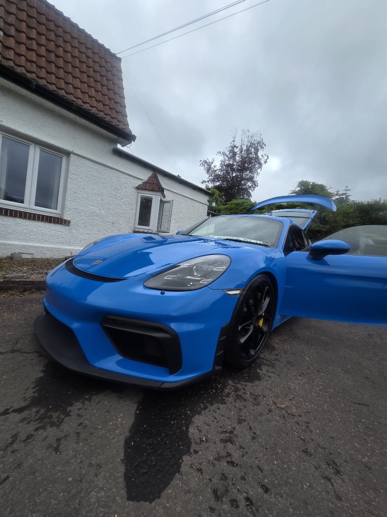 Full Valet — Blue Porsche coupe with passenger door open