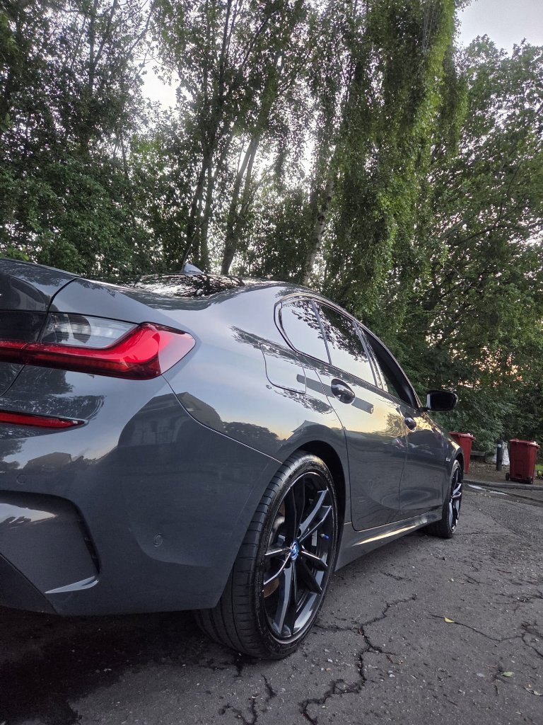 Grey BMW sedan — rear passenger side with high-gloss finish