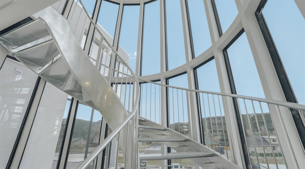 Spiral staircase inside curved glass tower