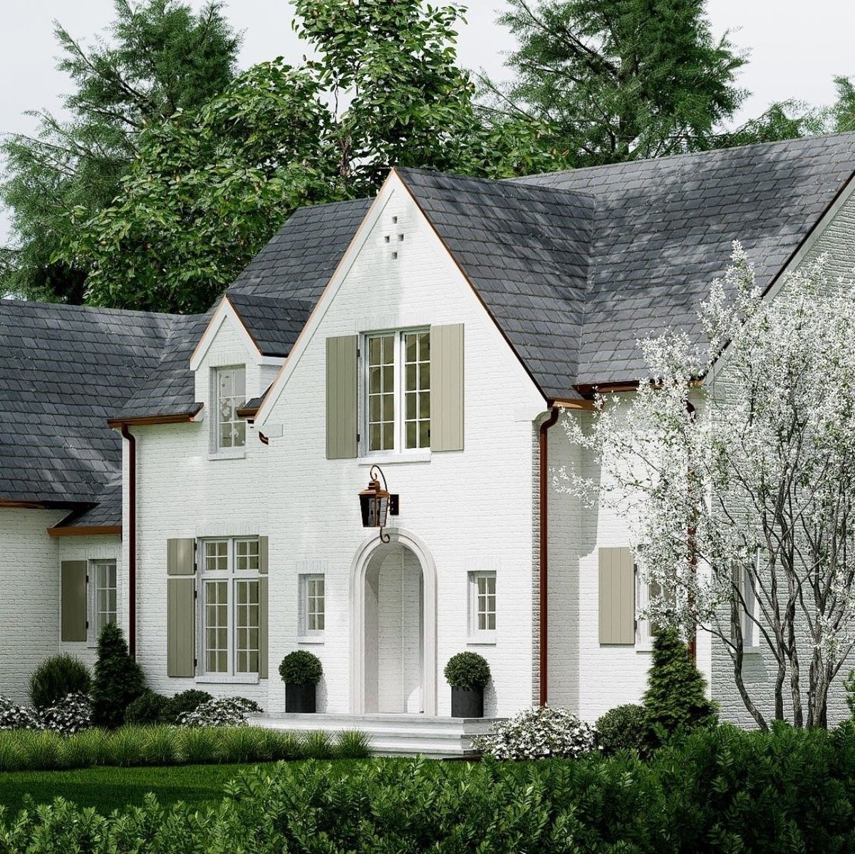 White brick home with copper gutters and slate roof