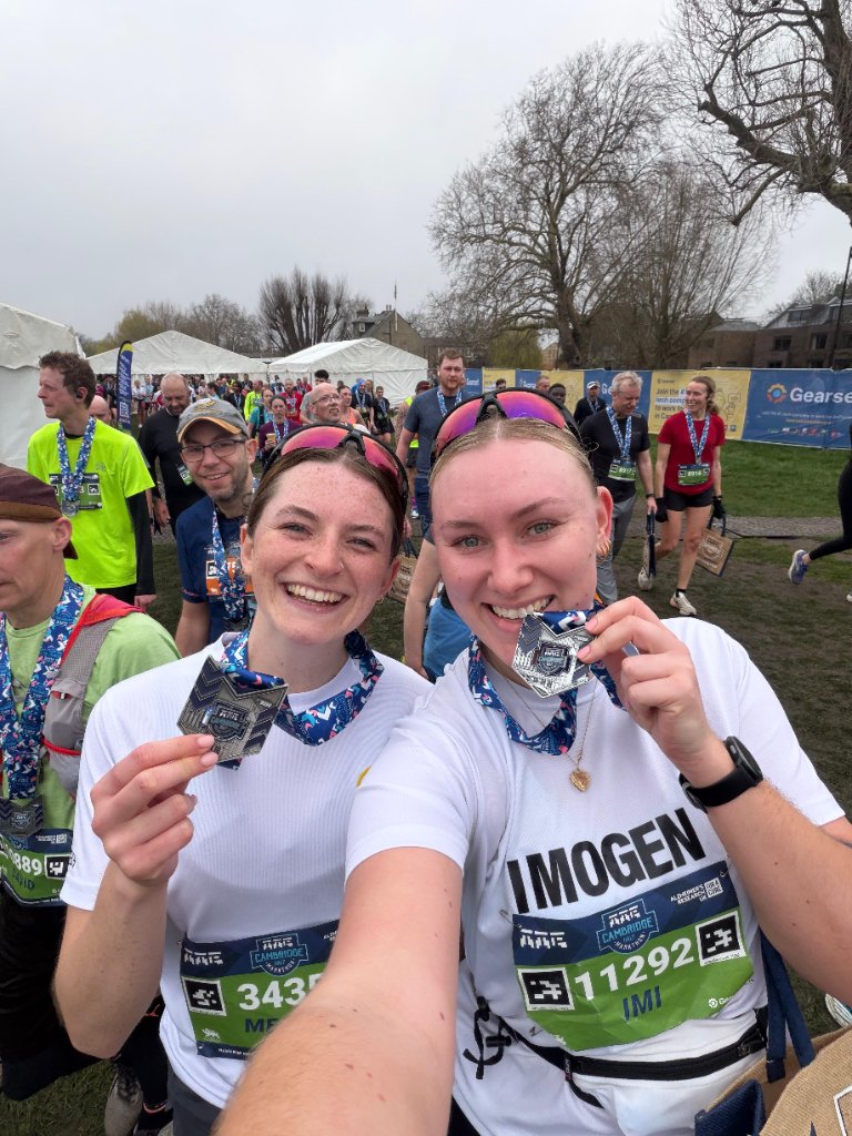 Runners celebrating with race medals