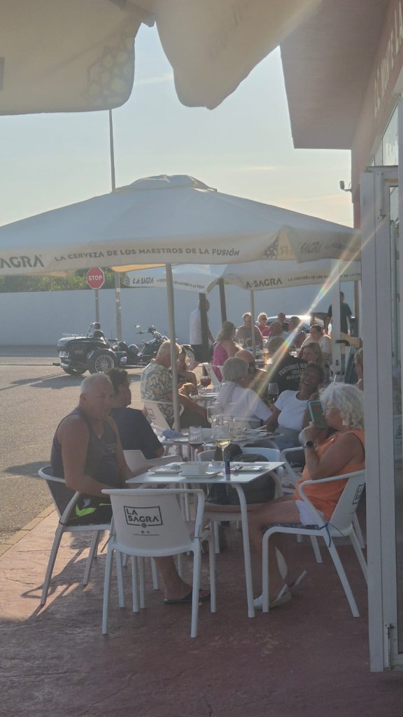 Busy sunny terrace full of guests