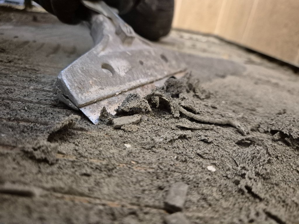 Scraping away old floor material during substrate preparation