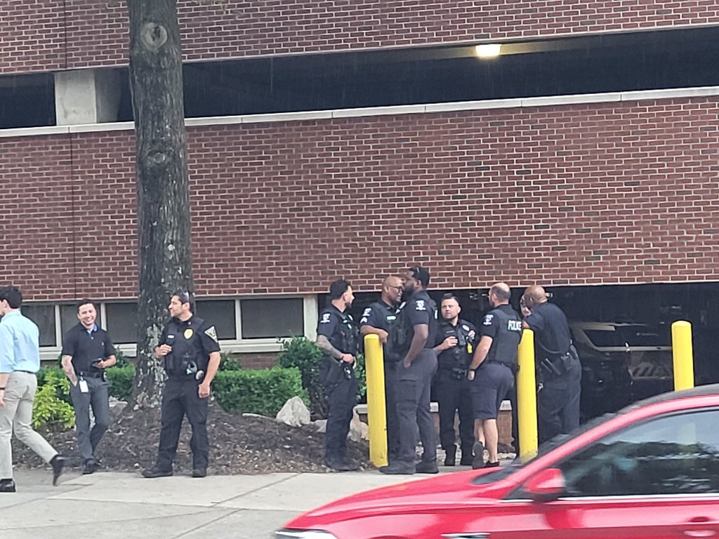 A group of police officers gathered near the CPCC parking structure during the student action