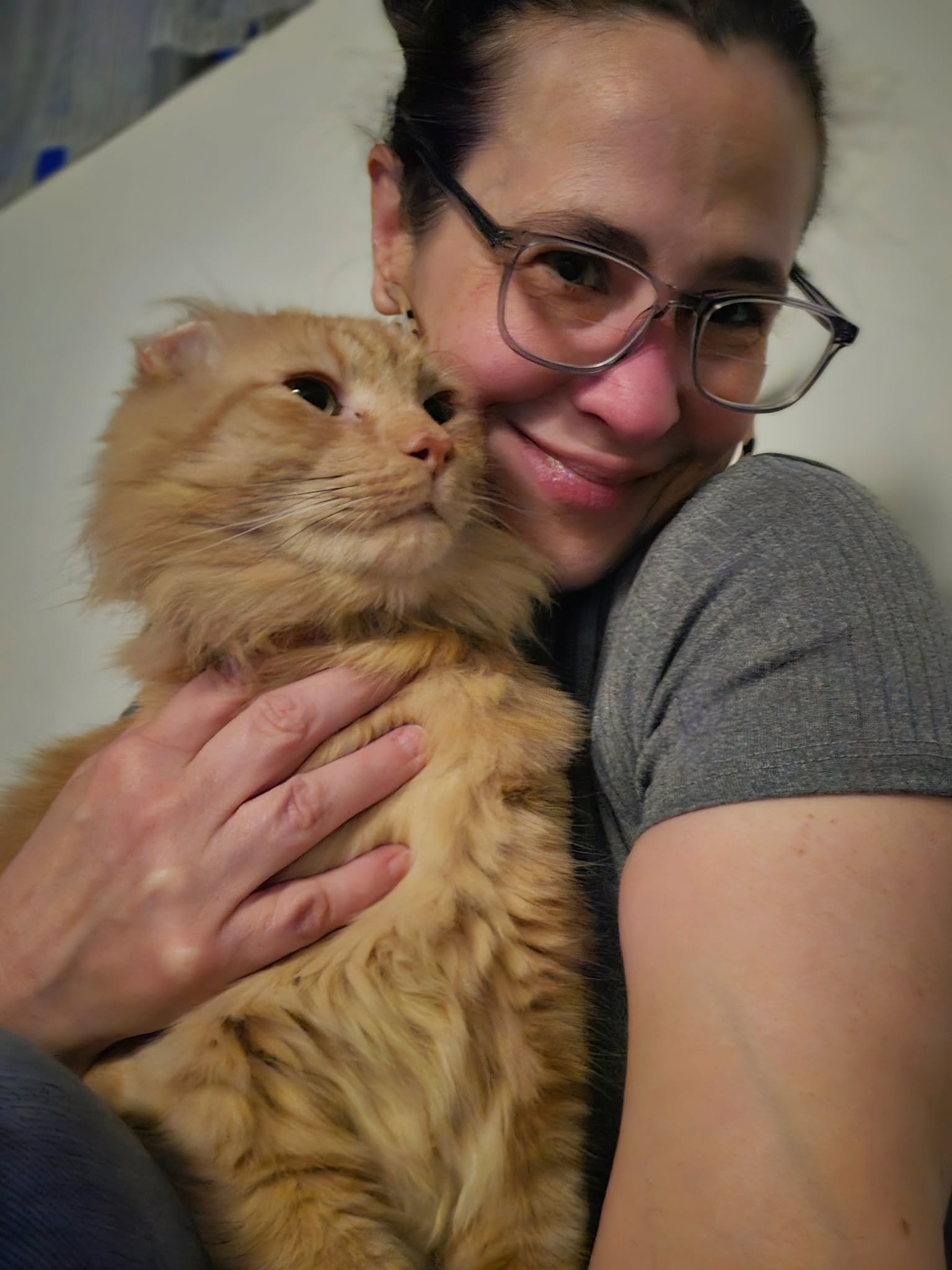 Mr. Thumbs being held by a smiling visitor