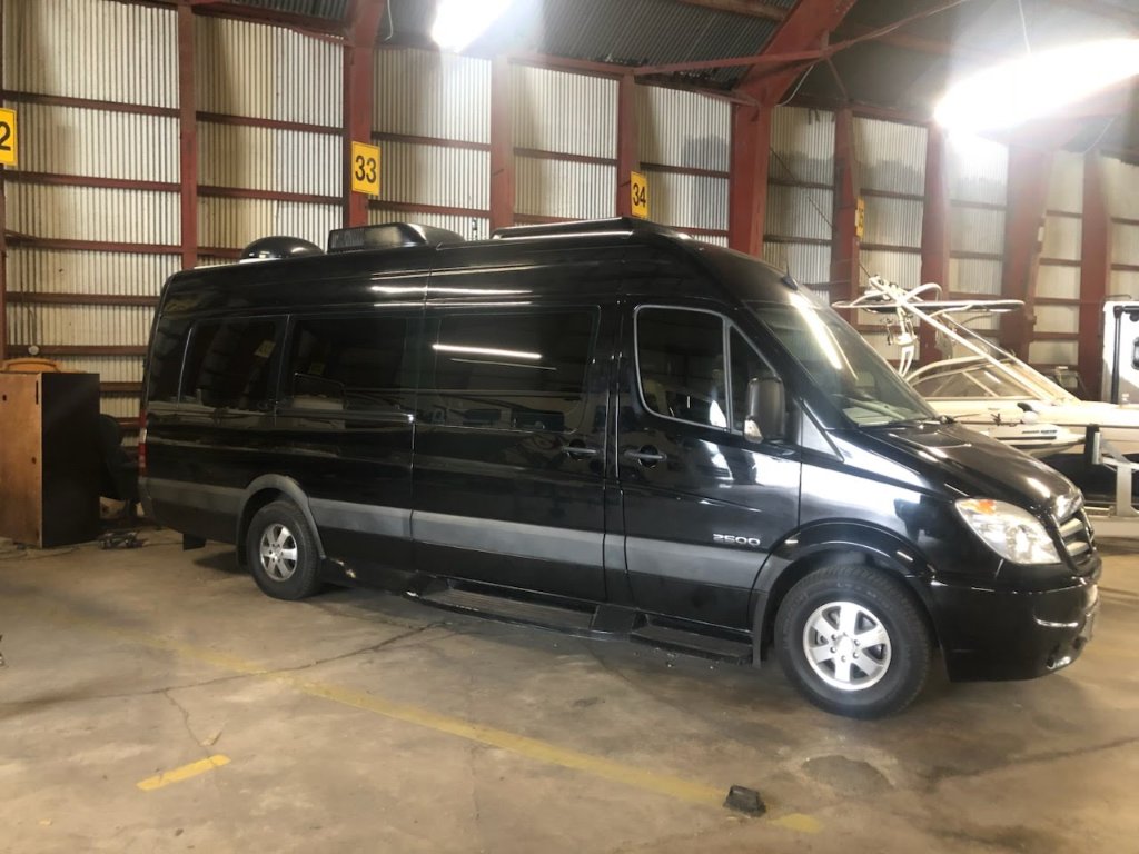 Luxury party bus with neon lights at night