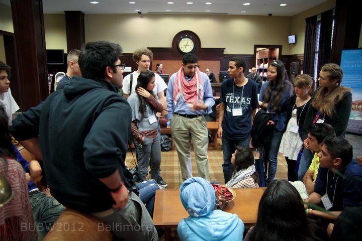 Hamza is pictured here teaching students from across the world about the Holocaust
