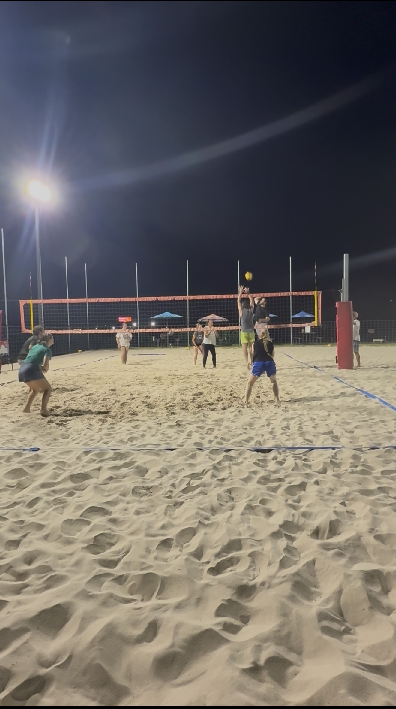 Houston Spike Series Wednesday Night Coed 4s beach volleyball action under the stadium lights.