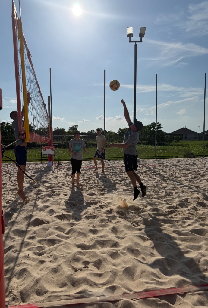 Player spiking at the net daytime