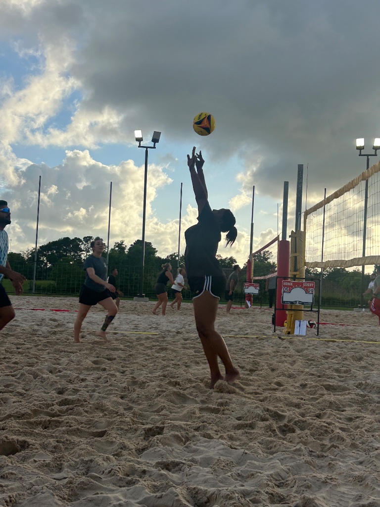 Player setting ball at the net under stormy sky