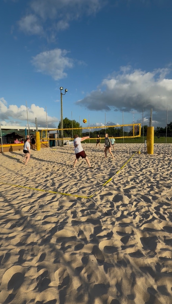 Houston Spike Series Thursday Night Coed 4's beach volleyball action during golden hour.