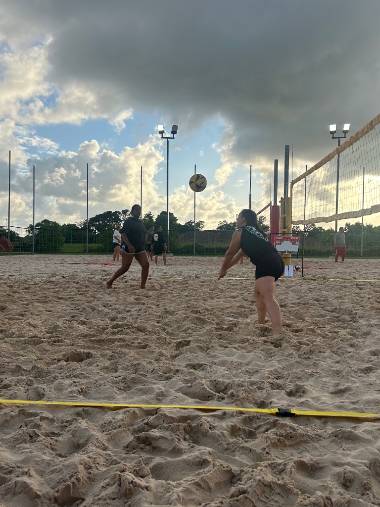Coed match in progress at dusk