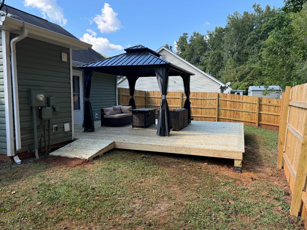 Freestanding gazebo with wood fence