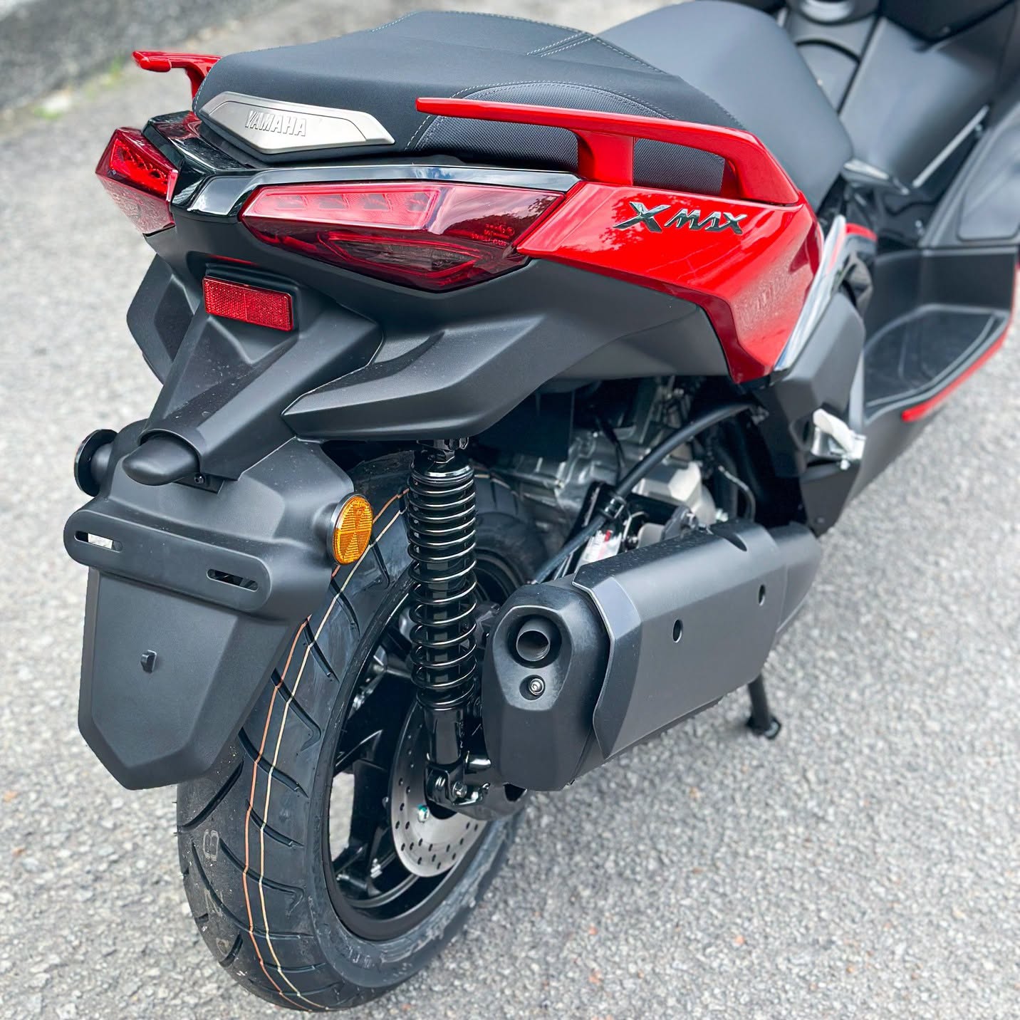 Yamaha XMAX 250 rear three-quarter detail showing taillight, grab rail and XMAX decal