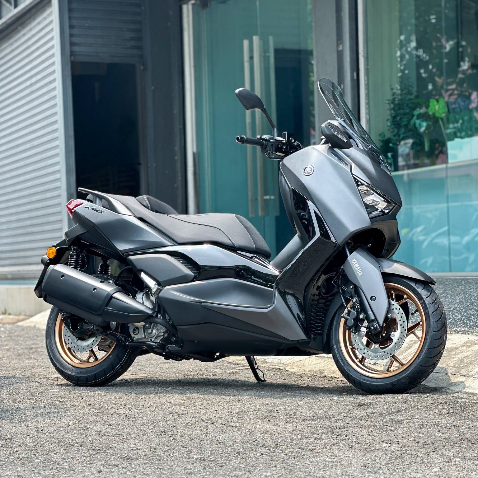 Yamaha XMAX 300 three-quarter front view parked on asphalt