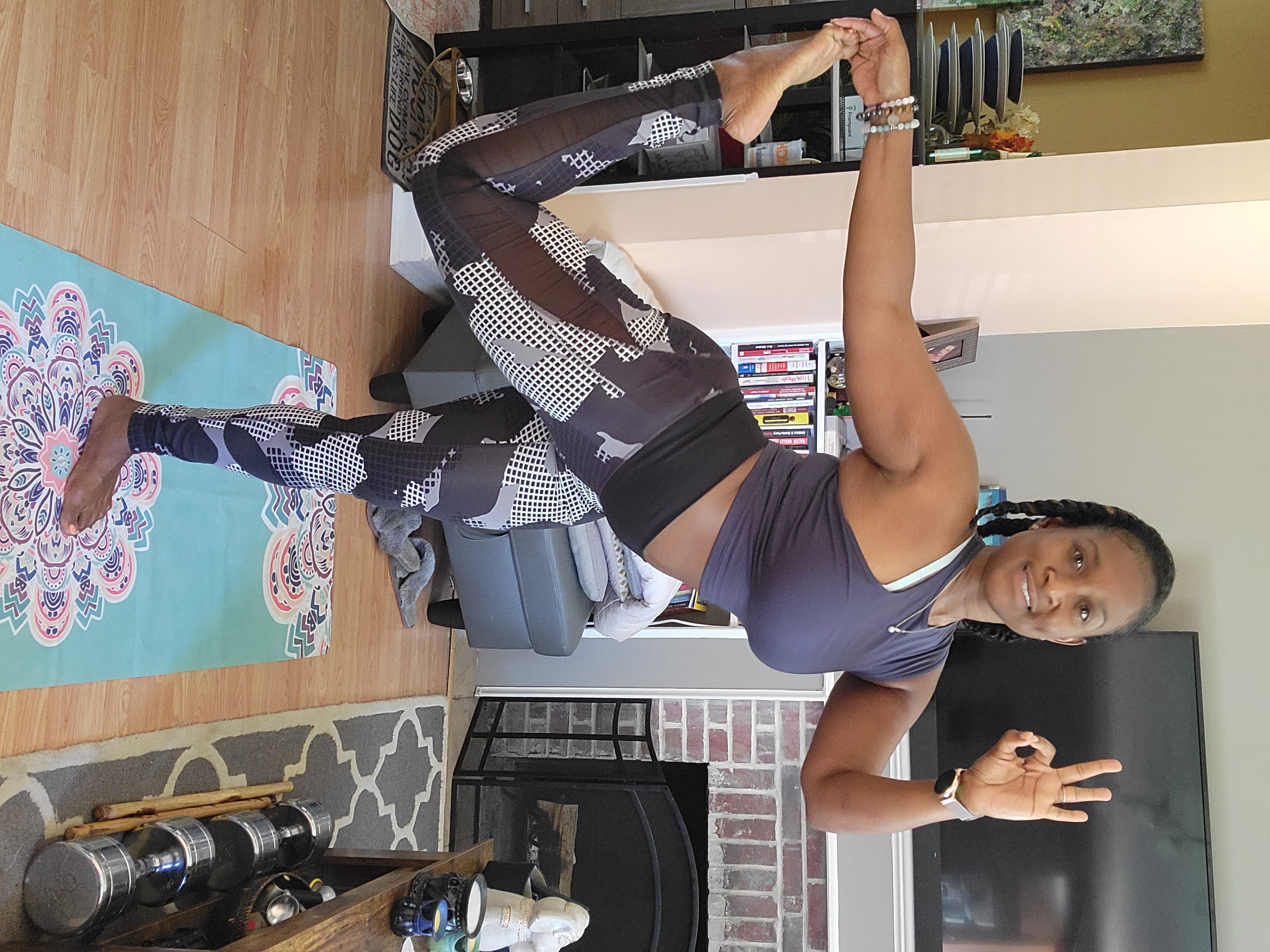Queen Mercy in a dancer's yoga pose, embodying strength and discipline