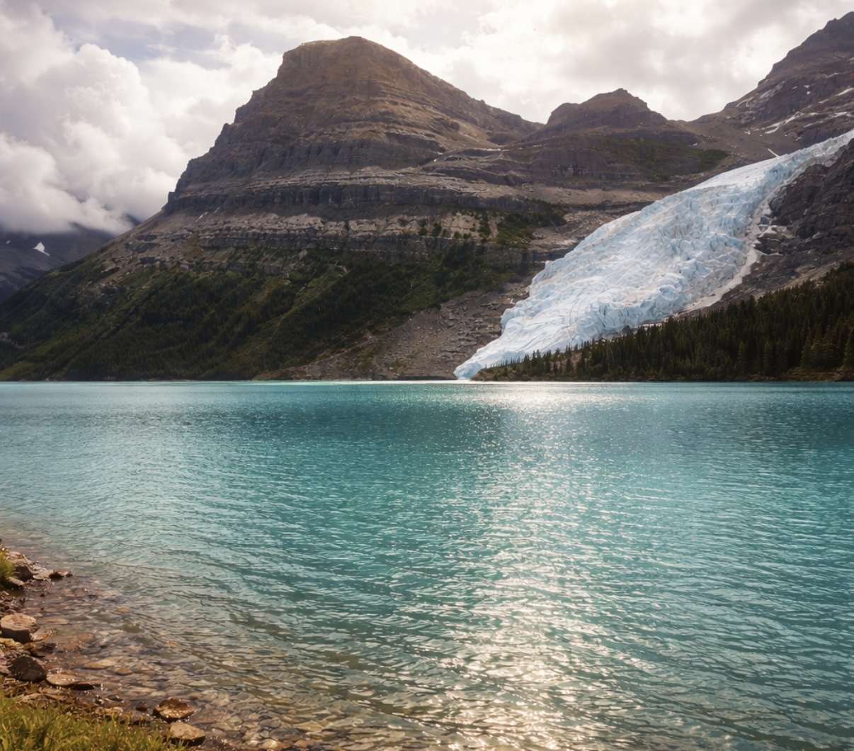 A turquoise glacial lake surrounded by mountains