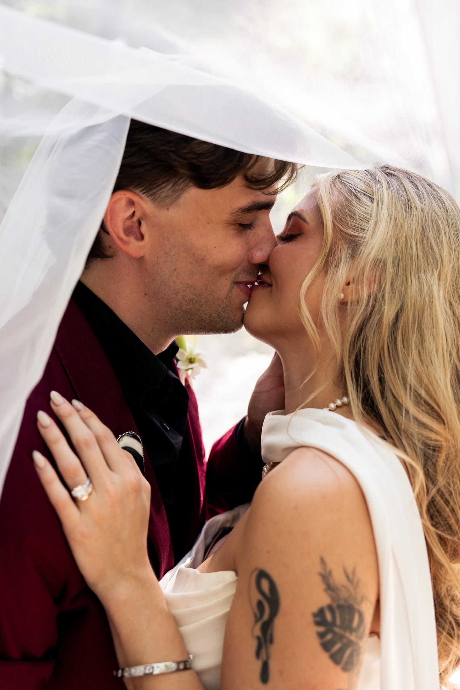 Close portrait of the couple beneath the bride veil at Garvan Woodland Gardens, Hot Springs, Arkansas