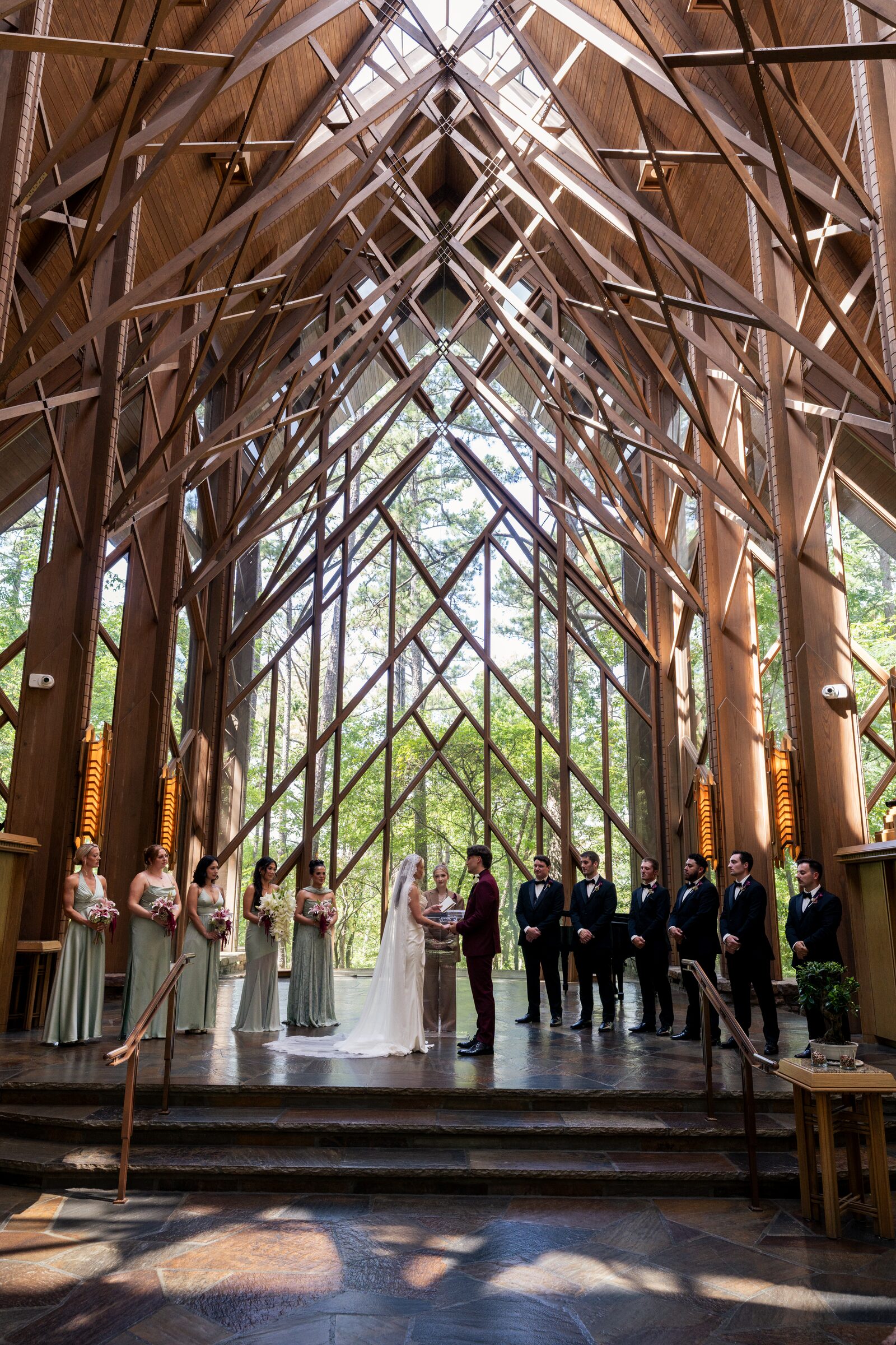 Bride and groom facing each other at the altar with their wedding party at Garvan Woodland Gardens, Hot Springs, Arkansas