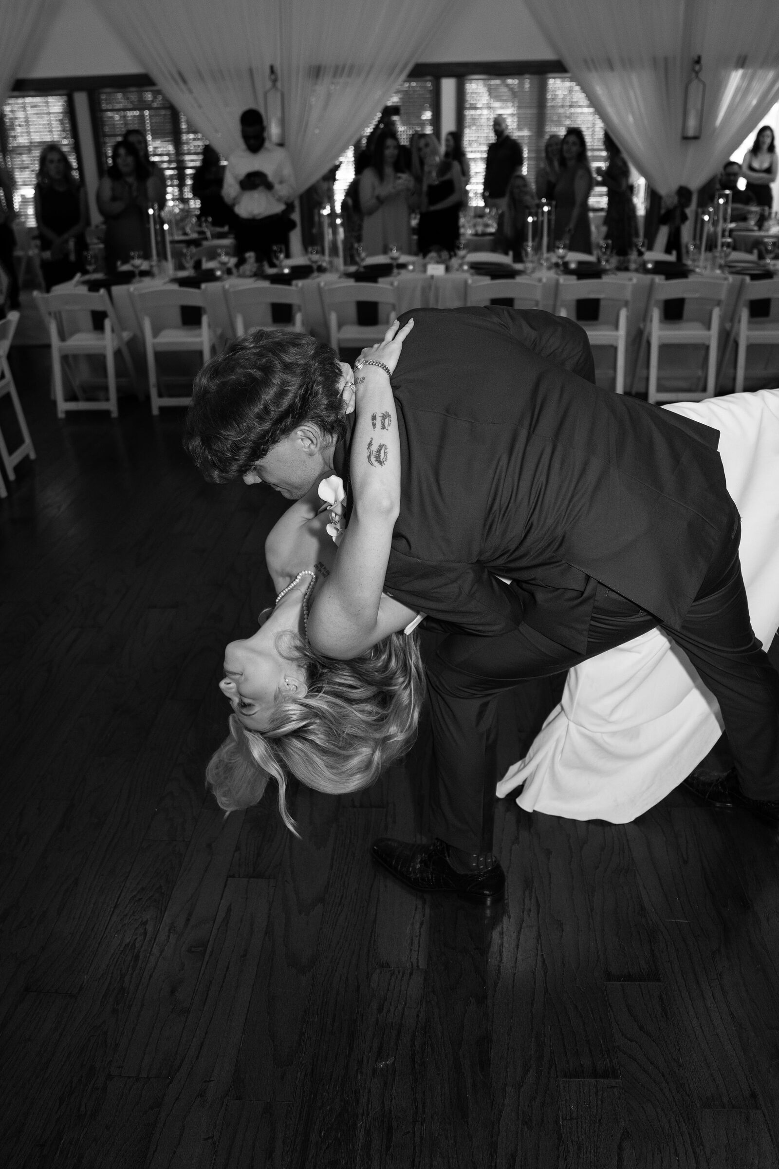 Black and white candid shot of the couple dancing at their reception at Garvan Woodland Gardens, Hot Springs, Arkansas