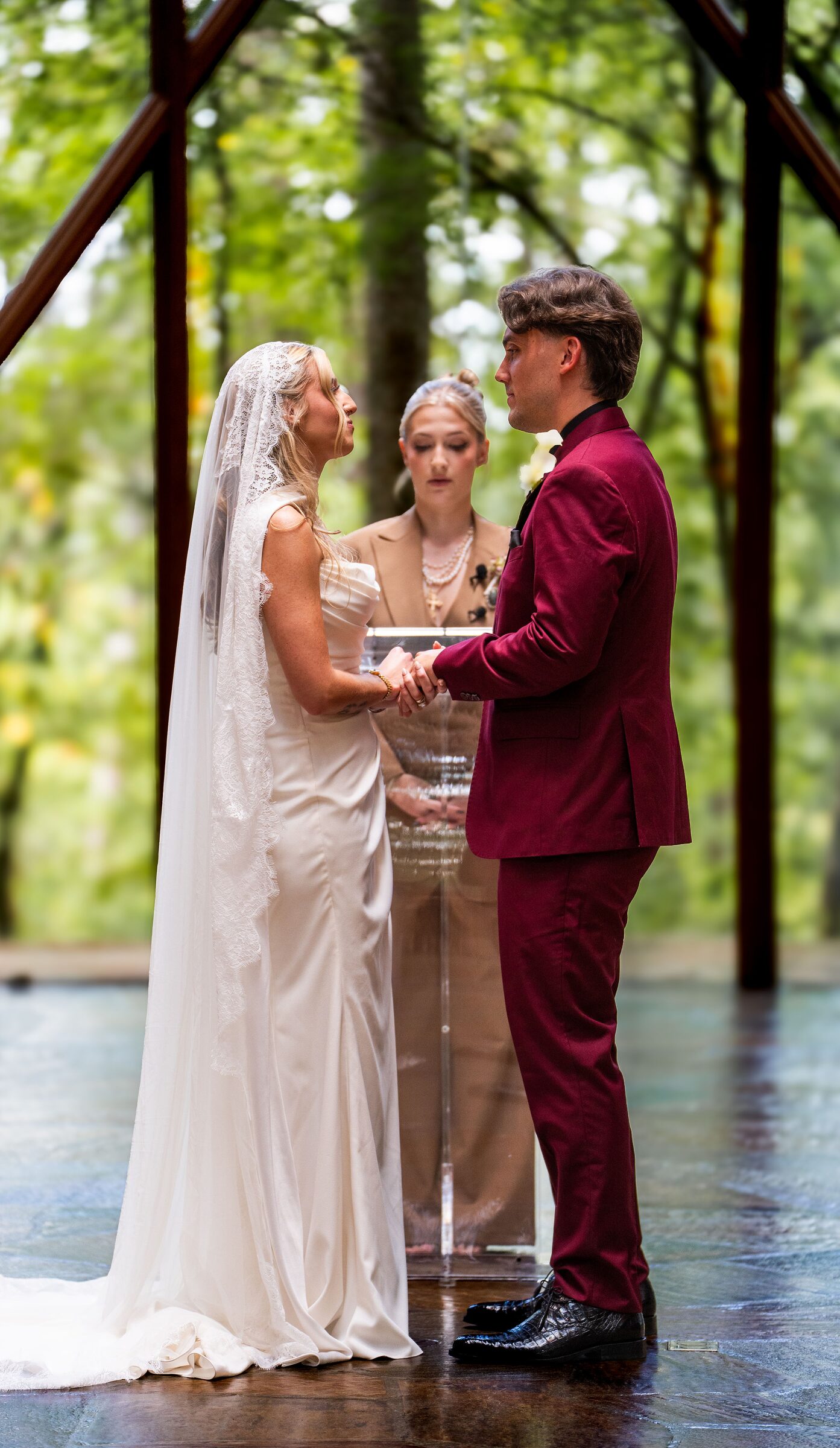 Bride and groom holding hands during their wedding ceremony at Garvan Woodland Gardens, Hot Springs, Arkansas