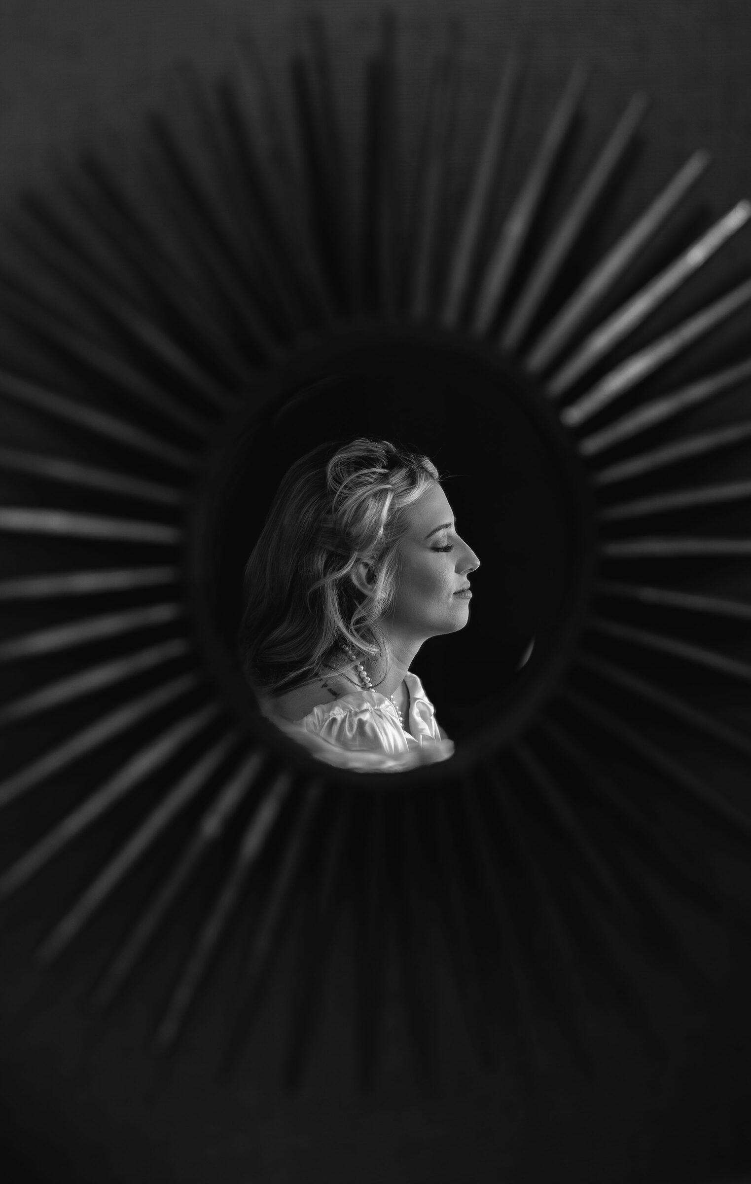 Black and white portrait of the bride reflected in a sunburst mirror at Garvan Woodland Gardens, Hot Springs, Arkansas